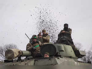 FILE PHOTO: Ukrainian service members ride a self-propelled howitzer near Bakhmut