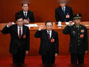 Newly-elected Chinese state councilors Qin Gang, Wu Zhenglong and Li Shangfu swear an oath after they were elected during the fifth plenary session of the National People's Congress (NPC) at the Great Hall of the People in Beijing on March 12, 2023. (Photo by NOEL CELIS / AFP)