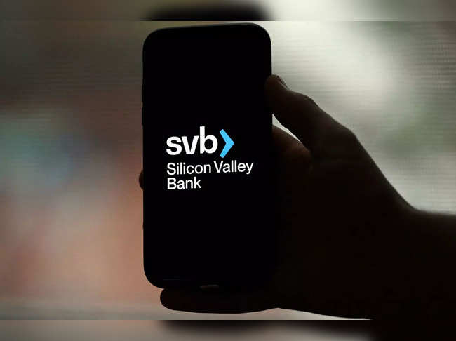 This illustration picture shows the Silicon Valley Bank (SVB) logo displayed on a smartphone in Arlington, Virginia, on March 10, 2023.  US authorities on March 10, 2023, shut SBV to protect depositors and will reopen branches on March 13 under a federally-run entity, US and California officials. California-based SVB was closed by the California Department of Financial Protection and Innovation, which appointed the Federal Deposit Insurance Corporation as receiver of the funds, the FDIC said. (Photo by OLIVIER DOULIERY / AFP)