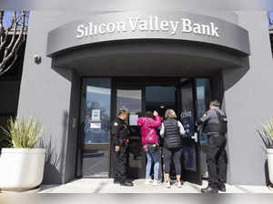 Security guards let individuals enter the Silicon Valley Bank's headquarters in ...