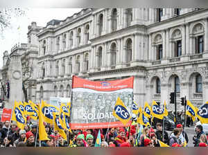 Demonstrators hold placards, flags and chant slogans as they take part in a protest of civil servant called by the British trade union Public and Commercial Services Union (PCS) amid a dispute with the government over pay, outside Downing Street in London, on March 15, 2023. Teachers, London Underground train drivers and civil servants joined striking doctors Wednesday in a mass stoppage as Britain's finance minister unveiled his tax and spending plans. With hundreds of thousands of walking out, it is expected to be the biggest single day of industrial action since a wave of unrest began last year. (Photo