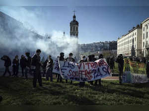 Protesters stand in the tear gas during a demonstration in Lyon, central France....
