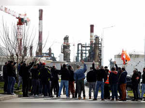 Workers on strike gather in front of the oil giant TotalEnergies refinery in Donges