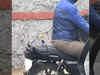 Barbie Doll attached to man's bike pillion seat by black string. Photo goes viral