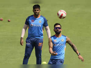 India's Virat Kohli, right, and Surya Kumar Yadav attend a practice session befo...