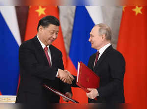 Russian President Vladimir Putin, right, and Chinese President Xi Jinping shake ...