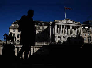 A person walks outside the Bank of England in the City of London financial district in London