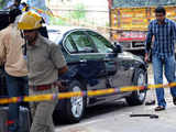 Security personnel inspect a car after blast