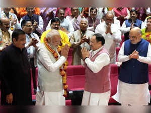 New Delhi: Prime Minister Narendra Modi being felicitated by BJP National Presid...