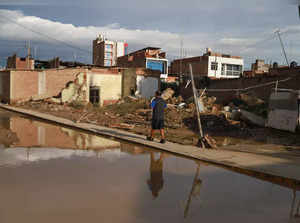 A resident walks among devastated neigborhoods and homes of the semi rural district of Illimo in the Piura region in north Peru, on March 11, 2023, after heavy rains caused by the presence of an "unorganized cyclone”, named Yaku, off the Peruvian coast, in the waters of the Pacific Ocean, according to the authorities.  The floods, accompanied by strong winds that affect part of Peru, started this week and grew in proportions in the last 48 hours, affecting urban and rural areas of the coastal departments of La Libertad, Lambayeque, Piura and Tumbes, on the border with Ecuador. "Cyclone