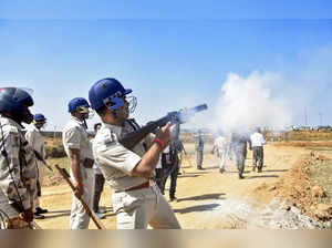 Ranchi: A policeman fires a tear gas shell to disperse students protesting again...