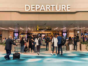 Trallers arrive at the departure hall in Singapore Changi airport in Singapore on March 31, 2023. A disruption at automated immigration clearance counters on March 31 led to rare delays at Singapore's Changi airport, affecting hundreds of travellers. (Photo by Catherine Lai / AFP)