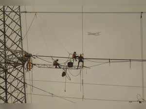 Navi Mumbai: Workers set up a new overhead line for electricity connection atop ...