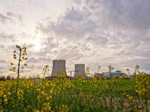 A photograph shows two cooling towers of the Nuclear power plant of Saint-Laurent-des-Eaux next to a rapeseed field, in Saint-Laurent-Nouan, central France, on March 30, 2023. On the banks of the Loire, reactor No. 2 of the Saint-Laurent-des-Eaux power plant has stopped delivering its megawatt hours to accommodate an army of workers in the service of a gigantic construction site: it's time to "check -complete upgrade" to allow it to produce 10 more years, with climate change in sight. (Photo by GUILLAUME SOUVANT / AFP)