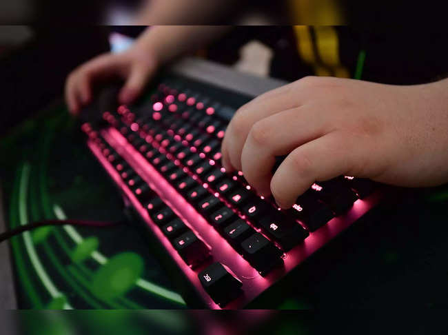 (FILES) In this file photo taken on January 16, 2019, a gamer of the eSports outfit Team Vitality types on a keyboard in the training room  at a "Gaming House" in Berlin's western suburb Halensee.  Berlin, which is hosting the European championships of the world's most popular online video game "League of Legends" until the end of March, is a hotbed of eSports talent with several European teams making their base in Berlin for the championships. The idea of a "Gaming House" allows team-mates to live and play together under one roof, with hours dedicated to improving on-line