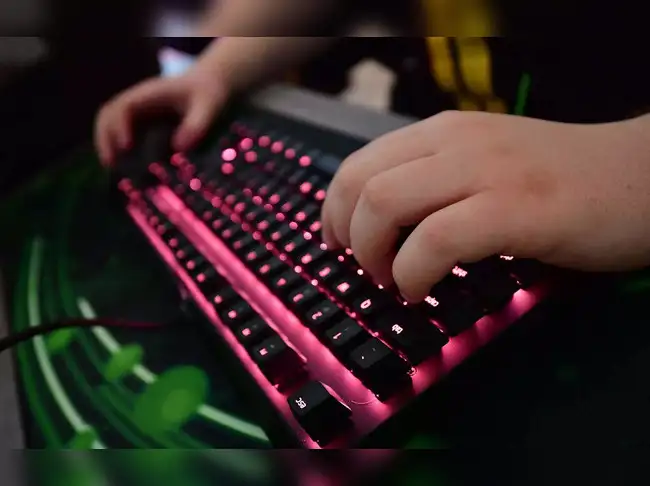 (FILES) In this file photo taken on January 16, 2019, a gamer of the eSports outfit Team Vitality types on a keyboard in the training room  at a "Gaming House" in Berlin's western suburb Halensee.  Berlin, which is hosting the European championships of the world's most popular online video game "League of Legends" until the end of March, is a hotbed of eSports talent with several European teams making their base in Berlin for the championships. The idea of a "Gaming House" allows team-mates to live and play together under one roof, with hours dedicated to improving on-line