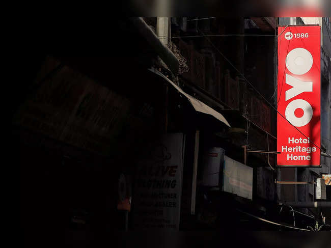 FILE PHOTO: The logo of OYO, India's largest and fastest-growing hotel chain, installed on a hotel building is pictured in an alley in New Delhi