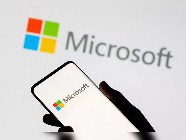 FILE PHOTO: Smartphone is seen in front of Microsoft logo displayed in this illustration taken
