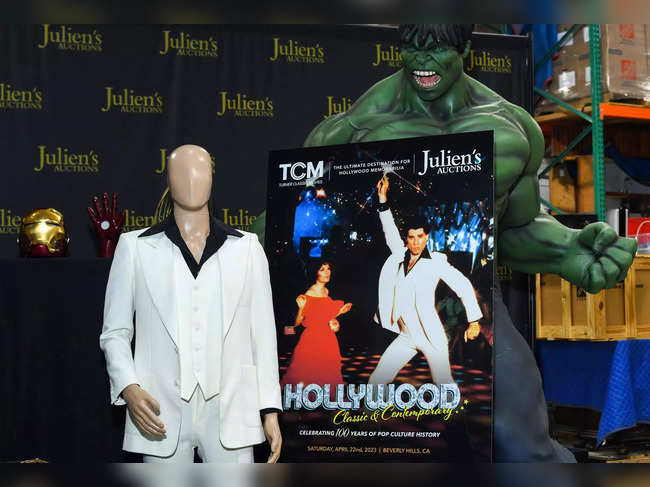 The custom-made white suit worn by John Travolta in "Saturday Night Fever" and an original Hulk figure from the premiere of "The Incredible Hulk" are displayed at Julien's Auctions in Gardena, California, on April 3, 2023. Julien's auction "Hollywood: Classic and Contemporary" celebrating 100 years of pop culture history will go on April 22 and 23, 2023.   (Photo by VALERIE MACON / AFP)