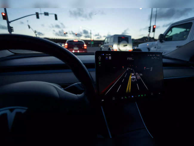 FILE PHOTO: Tesla Model 3 uses autopilot FSD beta to navigate city streets in California