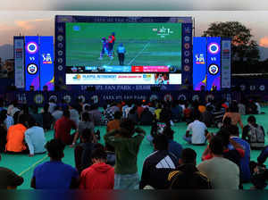 Dehradun: Cricket fans watch the IPL match on a big screen at the Tata IPL Fan P...