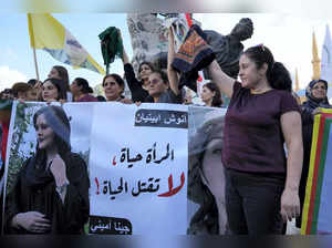Beirut: Kurdish women activists hold headscarfs and a portrait of Iranian woman ...