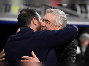 Real Madrid's Italian coach Carlo Ancelotti (R) hugs Chelsea's English coach Frank Lampard prior the UEFA Champions League quarter final first leg football match between Real Madrid CF and Chelsea FC at the Santiago Bernabeu stadium in Madrid on April 12, 2023. (Photo by JAVIER SORIANO / AFP)
