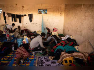 Migrants are seen in a transit centre in Assamaka, Niger, on march 29 2023. Every week, hundreds of migrants sent back from Algeria are stranded in Assamaka, the first village on the Niger border. They are now more than 4,500 wandering in this tiny patch of land swept by the winds. Malians, Guineans, Ivorians, Syrians, Bangladeshis discover a new purgatory after walking 15 km in the desert. (Photo by STANISLAS POYET / AFP)