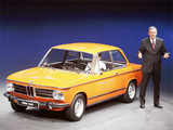 CEO of BMW Reithofer poses next to a vintage BMW 1602