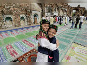 New Delhi: Muslim children greet each other after Eid prayers at Feroz Shah Kotl...