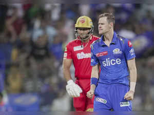 Mumbai:  Mumbai Indians' Jason Behrendorff celebrates the wicket of Punjab Kings...