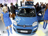 Models pose in front of a Fiat Panda