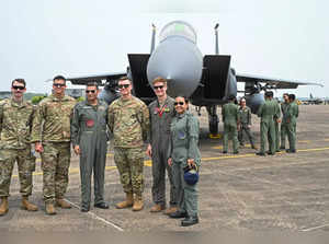 The United States Air Force (USAF) and Indian Air Force (IAF) personnel pose in front of a F-15 Eagle fighter jet during the joint 'Exercise Cope India 2023' between USAF and IAF at the air force station in Kalaikunda, in India's West Bengal state on April 24, 2023.  (Photo by Dibyangshu SARKAR / AFP)