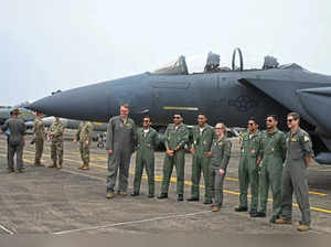The United States Air Force (USAF) and Indian Air Force (IAF) personnel pose in front of a F-15 Eagle fighter jet during the joint 'Exercise Cope India 2023' between USAF and IAF at the air force station in Kalaikunda, in India's West Bengal state on April 24, 2023.  (Photo by Dibyangshu SARKAR / AFP)