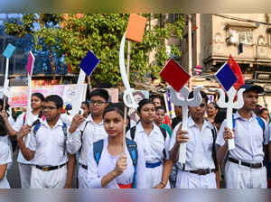 Kolkata: School students participate in a campaign promoting peace and education...