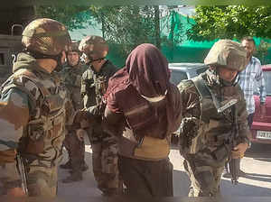 Poonch: Security forces personnel arrest a suspected terrorist in Poonch. (PTI P...