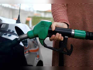 FILE PHOTO: A person uses a petrol pump, as the price of petrol rises, in Lisbon