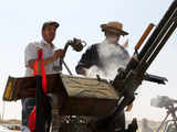 Men clean a 50 calibre anti-aircraft gun for anti-Gaddafi fighters