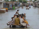 Flood-hit residents ride on donkey-carts in Sindh province