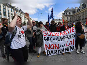 Protesters hold a banner which reads "Solidarity with asylum seekers" during a demonstration against the French Minister of Interior, Gerald Darmanin's legislative proposal on asylum and immigration, in Rennes, western France, on April 29, 2023. The French government is considering a draft law tightened up on the most technical aspects (reform of asylum procedures and the litigation of foreigners), to leave the most abrasive elements in the hands of the lawmakers, who could table bills on expulsions of foreigners (on the right) or integration through language and work (in the majority), the entourage of France's Interior minister explained to AFP