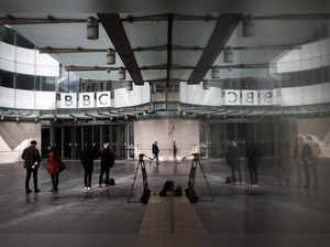 Members of the media work outside the BBC headquarters, in London