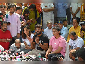 Indian wrestlers Bajrang Punia (C), Sakshi Malik (center R) and Vinesh Phogat (center L) address a press conference while taking part in an ongoing protest against the Wrestling Federation of India (WFI) in New Delhi on April 24, 2023, following allegations of sexual harassment to athletes by members of the WFI. (Photo by Sajjad HUSSAIN / AFP)