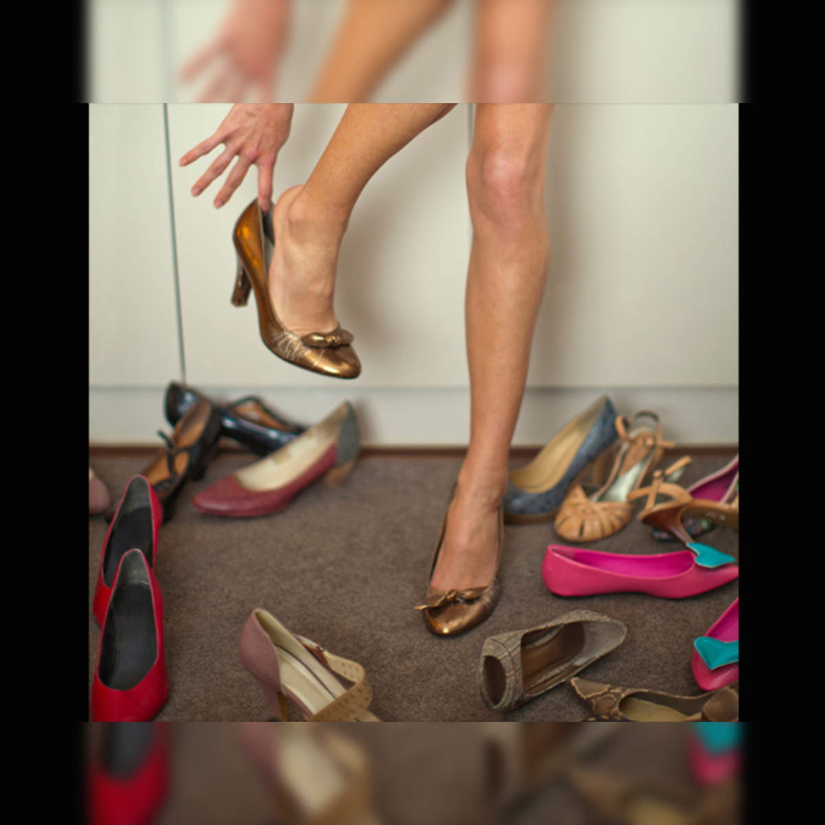 Woman Standing on the Stairs and Putting on High Heels · Free Stock Photo