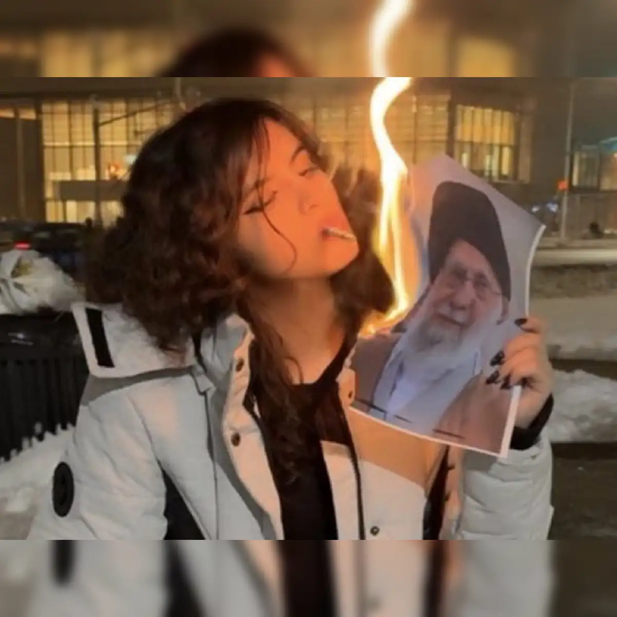 After 'bloody' protest, viral photos show Iranian women using Khamenei's  photos to light cigarettes. Here's why