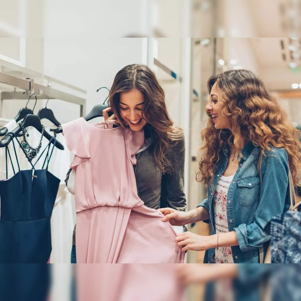 Smiling Woman Looking At Shirt While Shopping In A Clothing Store Stock  Photo - Download Image Now - iStock