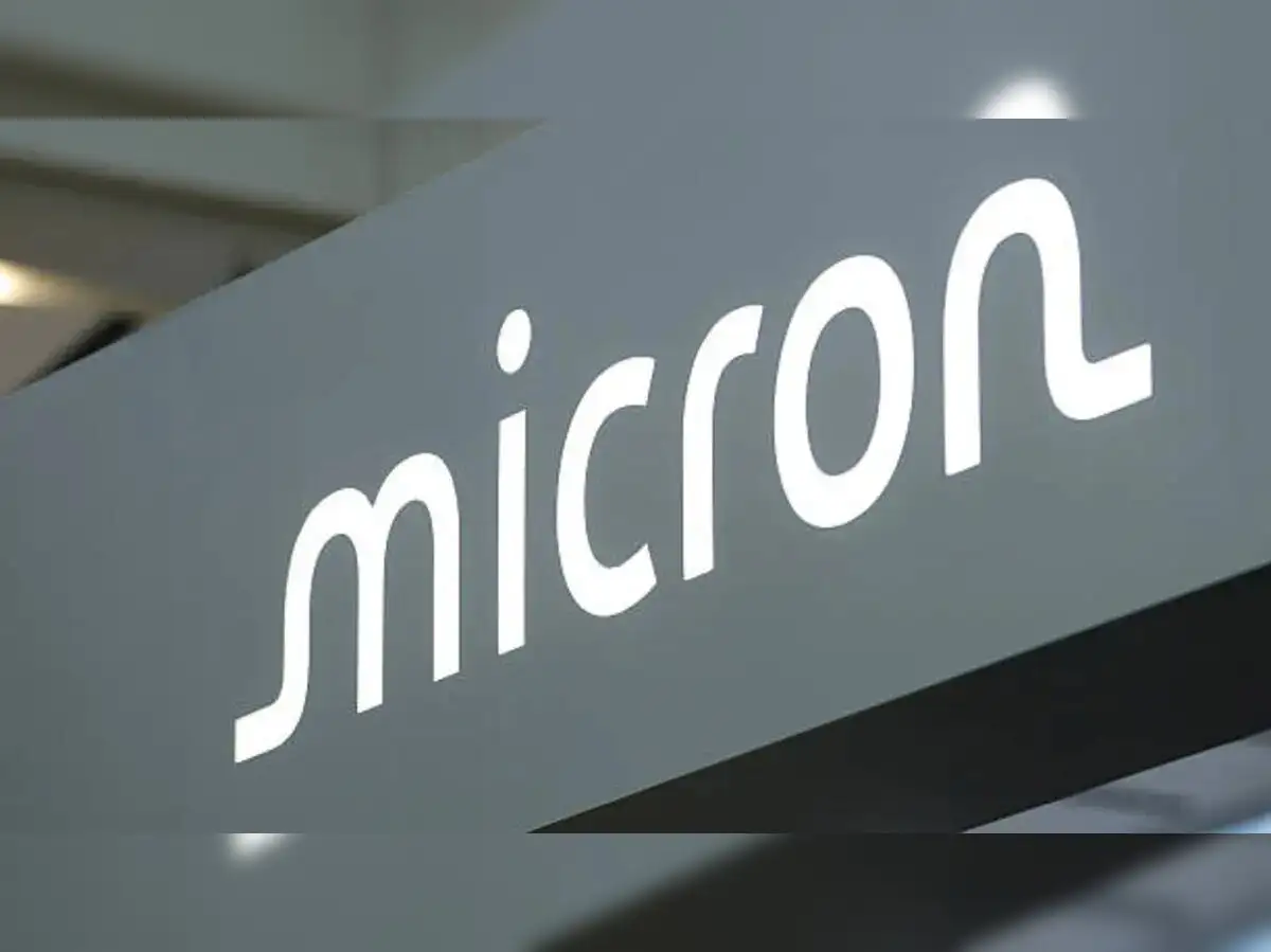 Micron semiconductor chip next to an upward trending stock chart with AI graphic overlays.