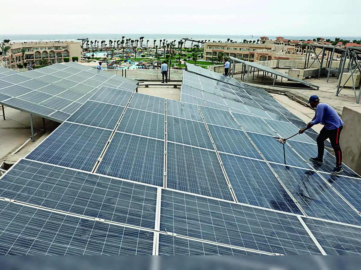 Image: A worker cleans solar cells on a rooftop of a hotel in the resort town of Sharm el-Sheikh, the first to operate a solar-powered plant in a bid to turn to clean energy as the city prepares to host the upcoming COP27 summit in November, in Sharm el-Sheikh, Egypt, June 4, 2022. Picture taken June 4, 2022. REUTERS/Mohamed Abd El Ghany
