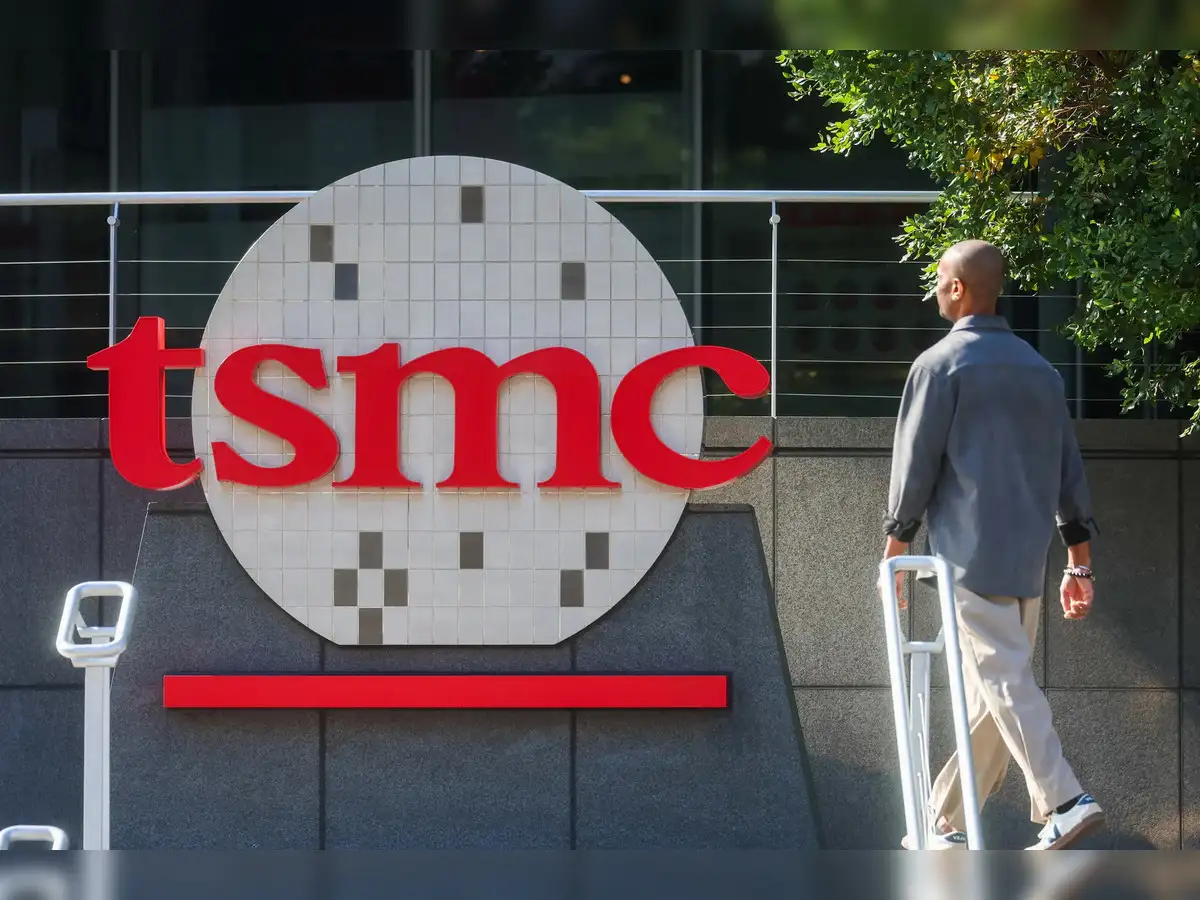 TSMC CEO C.C. Wei speaking at a podium, with an optimistic expression, symbolizing the company's positive outlook on the AI boom.