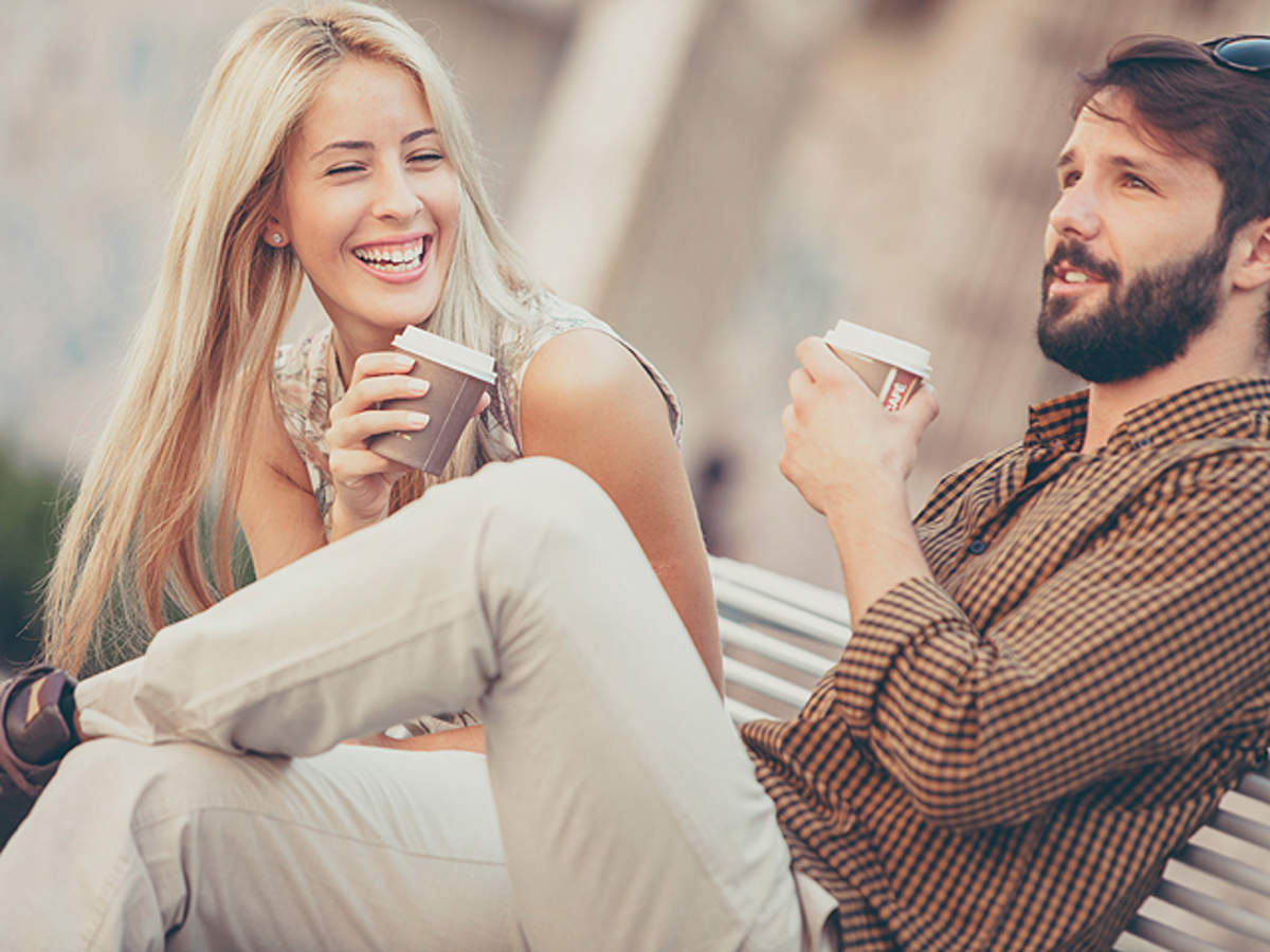 There's a man and a woman who are sitting together on the grass