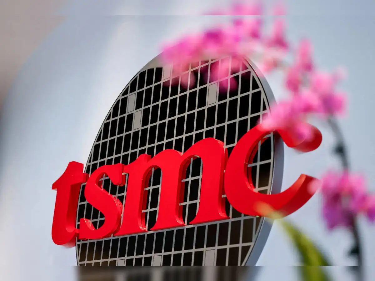 A stylized depiction of a TSMC semiconductor factory in Arizona, with AI chip imagery integrated.